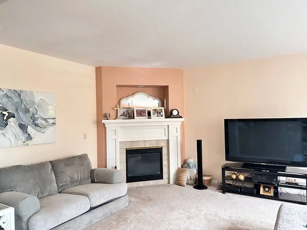 Living room interior painting with neutral wall colors and accent fireplace in Denver home