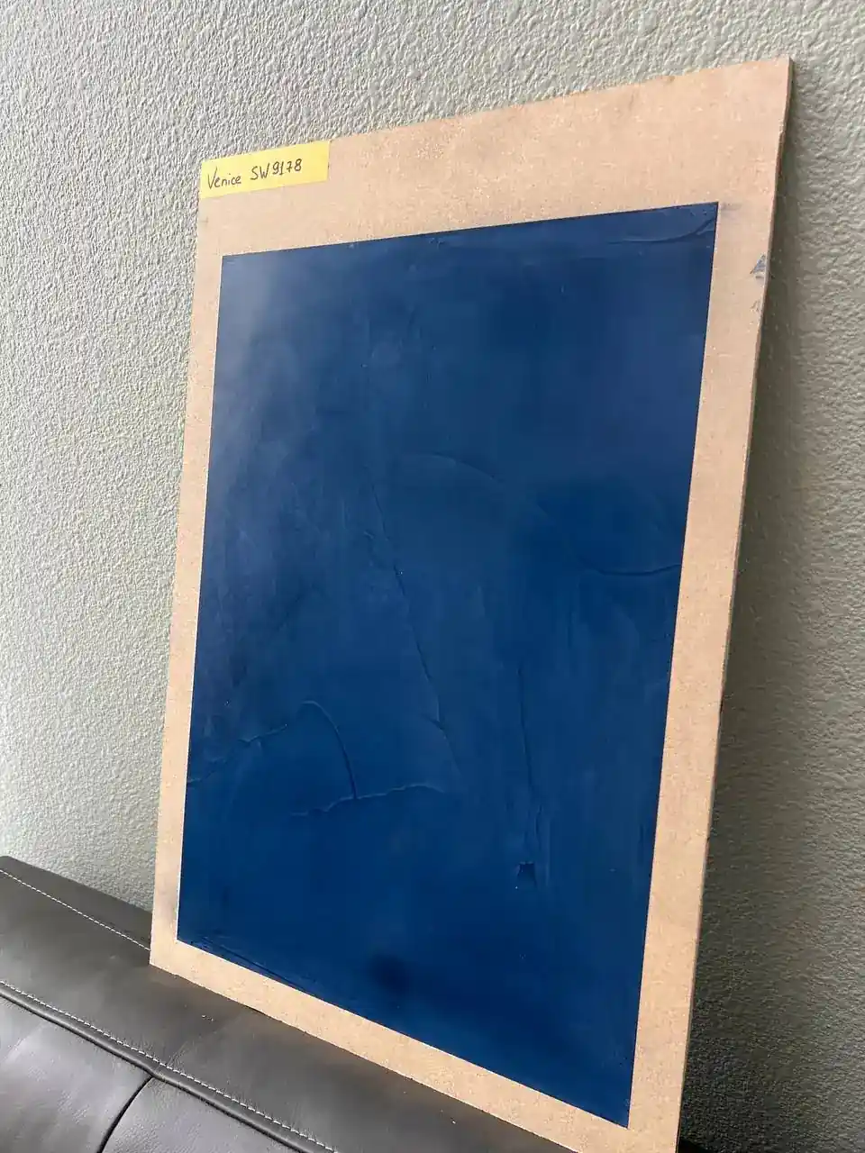Decorative plaster sample with smooth blue finish for interior walls
