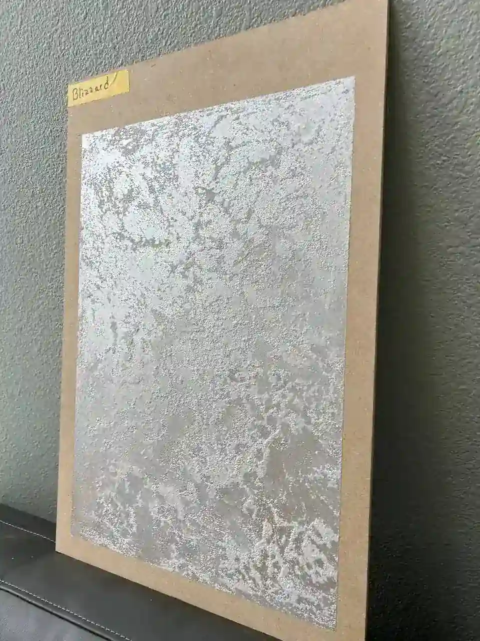 Decorative plaster wall sample with textured light finish for modern interiors