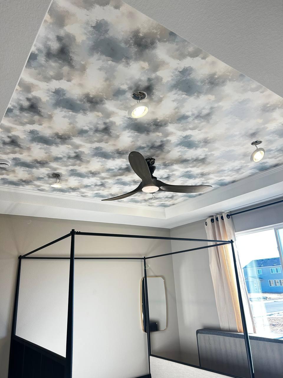 Ceiling wallpaper installation with cloud design and modern lighting