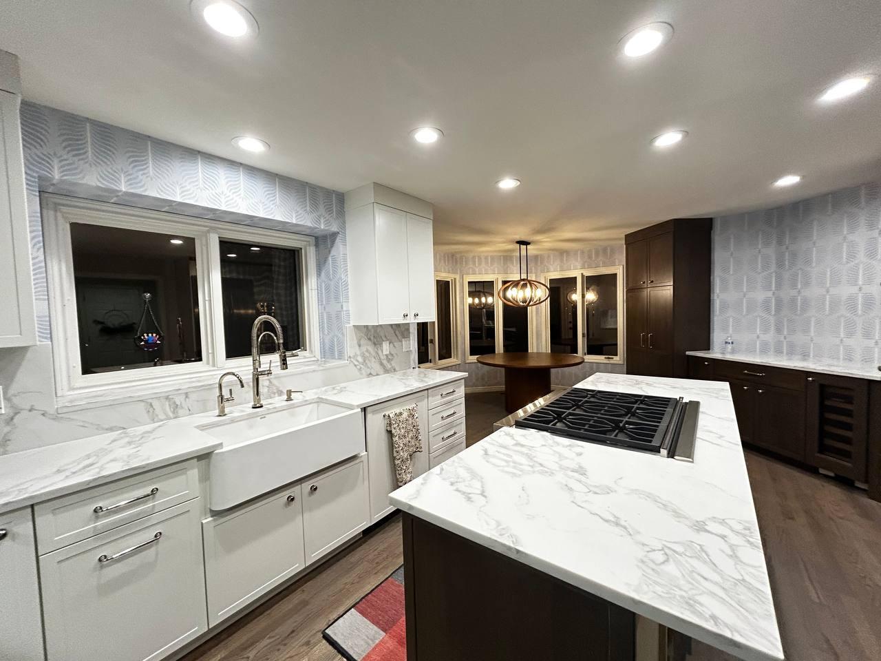 Kitchen interior with wallpaper backsplash and recessed lighting