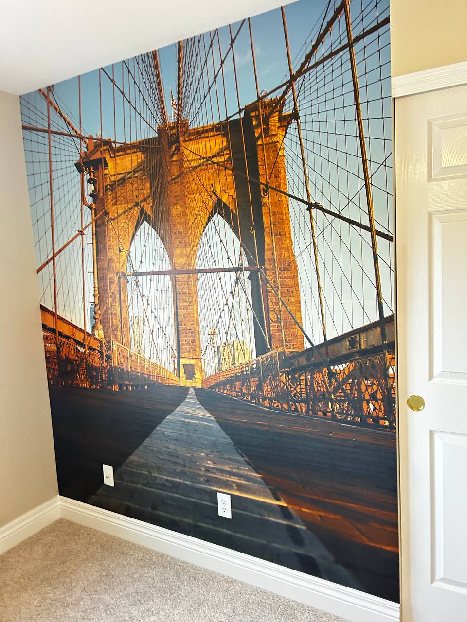 Custom wallpaper hanging with detailed pattern matching in a modern Colorado home